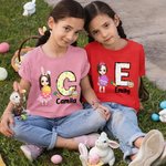 Personalisierte niedliche Holding Osterei Cartoon Junge Mädchen anfängliche 100 % Baumwolle Kind T-Shirt mit Namen Ostern Thema Party Favors Geschenk für Kinder