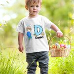 Personalisierte niedliche Holding Osterei Cartoon Junge Mädchen anfängliche 100 % Baumwolle Kind T-Shirt mit Namen Ostern Thema Party Favors Geschenk für Kinder