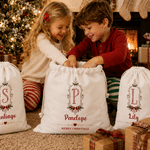 Borsa regalo con cordoncino in tela personalizzata con cornice vintage, motivo a fiocco di agrifoglio e iniziale, con nome – Regalo per la festa della vigilia di Natale per bambini e famiglia