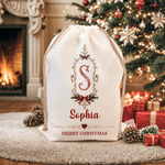 Borsa regalo con cordoncino in tela personalizzata con cornice vintage, motivo a fiocco di agrifoglio e iniziale, con nome – Regalo per la festa della vigilia di Natale per bambini e famiglia