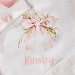 Spersonalizowany, wykonany w 100% z bawełny, miękki kombinezon dla dziewczynki z motywem kwiatowym i kokardką oraz czapeczką z imieniem – prezent na baby shower i urodziny dla noworodka oraz świeżo up 6